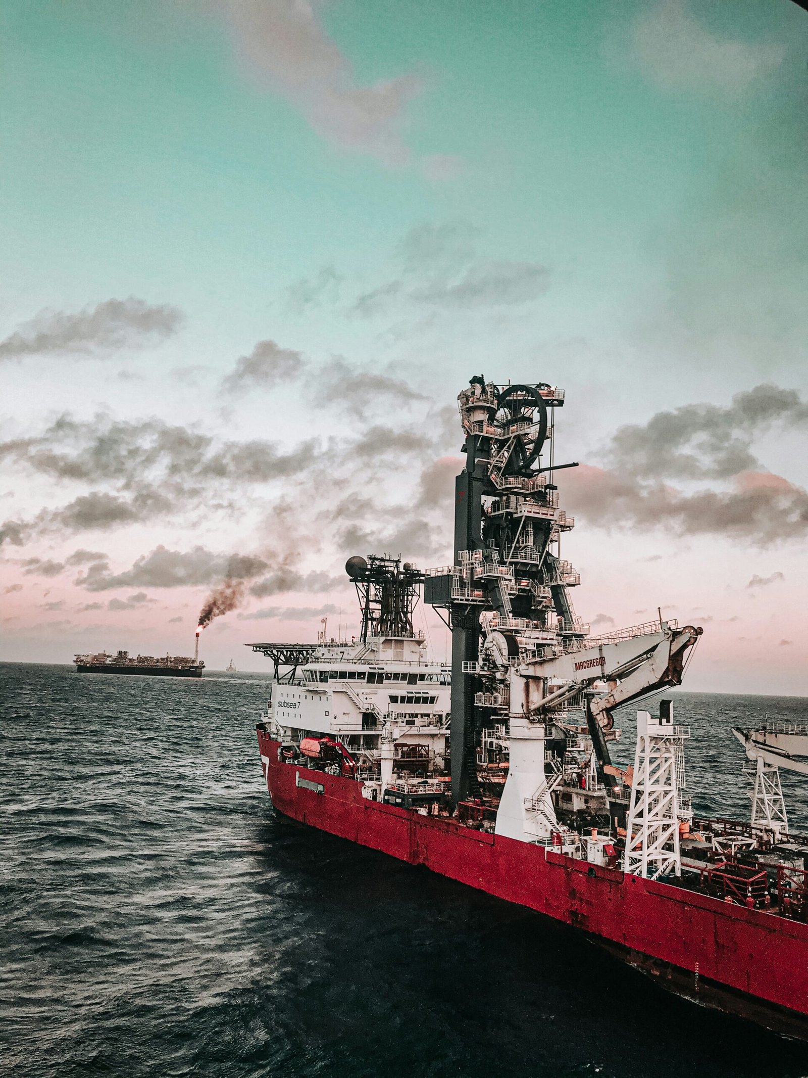 red and white ship on sea under cloudy sky during daytime